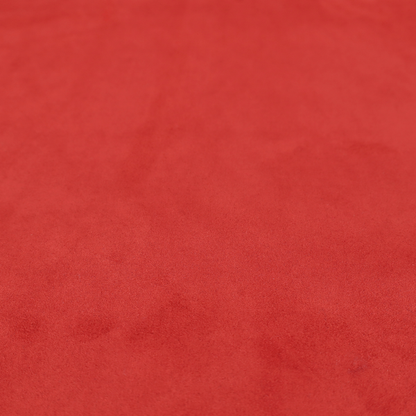 Annecy Water Repellent Velvet in Red. The fabric features a dense, plush pile with a soft matte finish in a bold, classic primary red. This high-performance upholstery material offers a luxurious feel and a specialized water-resistant coating for superior durability and a vibrant look.