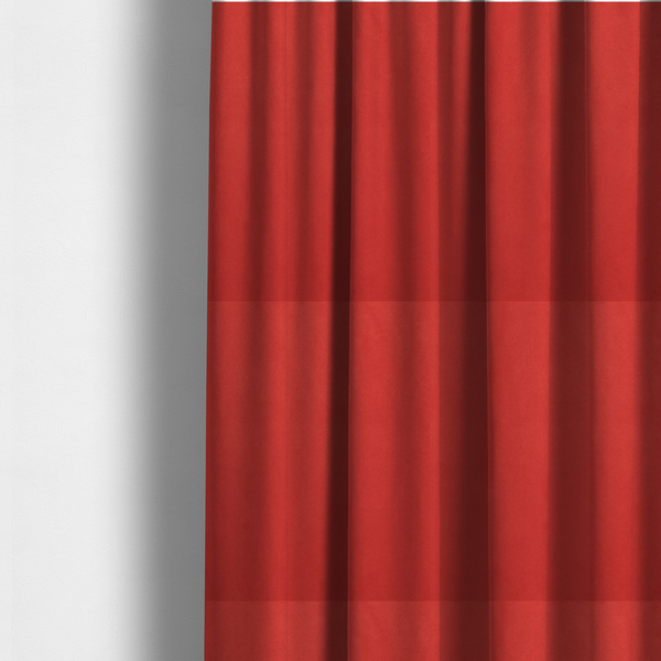 The fabric used to create these made-to-measure curtains features a dense, plush pile with a soft matte finish in a bold, classic primary red. This high-performance upholstery material offers a luxurious feel and a specialized water-resistant coating for superior durability and a vibrant look.
