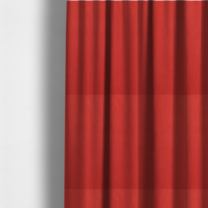 The fabric used to create these made-to-measure curtains features a dense, plush pile with a soft matte finish in a bold, classic primary red. This high-performance upholstery material offers a luxurious feel and a specialized water-resistant coating for superior durability and a vibrant look.