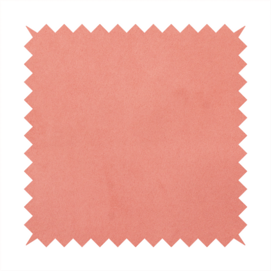 Annecy Water Repellent Velvet in Coral. The fabric features a dense, plush pile with a soft matte finish in a warm, vibrant pinkish-orange tone. This high-performance upholstery material offers a luxurious feel combined with a specialized water-resistant coating for enhanced durability and a fresh, modern look.