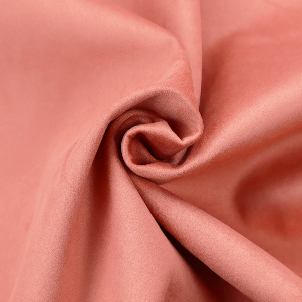 Annecy Water Repellent Velvet in Coral. The fabric features a dense, plush pile with a soft matte finish in a warm, vibrant pinkish-orange tone. This high-performance upholstery material offers a luxurious feel combined with a specialized water-resistant coating for enhanced durability and a fresh, modern look.