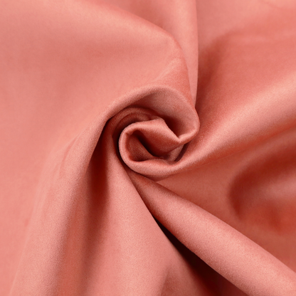 Annecy Water Repellent Velvet in Coral. The fabric features a dense, plush pile with a soft matte finish in a warm, vibrant pinkish-orange tone. This high-performance upholstery material offers a luxurious feel combined with a specialized water-resistant coating for enhanced durability and a fresh, modern look.