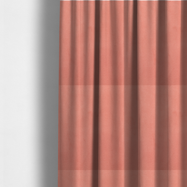 The fabric used to create these made-to-measure curtains  features a dense, plush pile with a soft matte finish in a warm, vibrant pinkish-orange tone. This high-performance upholstery material offers a luxurious feel combined with a specialized water-resistant coating for enhanced durability and a fresh, modern look.