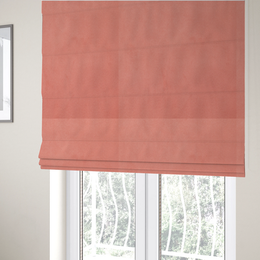The fabric used to create these Roman blinds features a dense, plush pile with a soft matte finish in a warm, vibrant pinkish-orange tone. This high-performance upholstery material offers a luxurious feel combined with a specialized water-resistant coating for enhanced durability and a fresh, modern look.