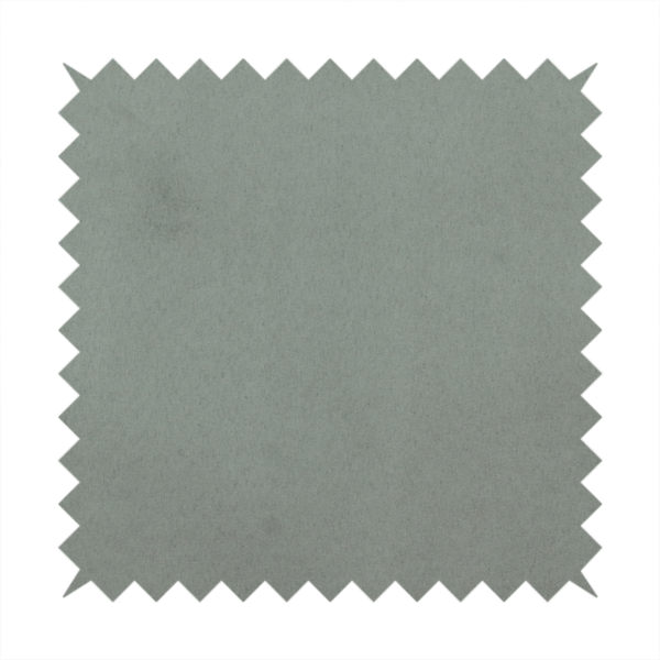 Annecy Water Repellent Velvet in Sage. The fabric features a dense, plush pile with a soft matte finish in a sophisticated, muted earthy green. This high-performance upholstery material offers a luxurious feel and a specialized water-resistant coating for enhanced durability and a natural, calming aesthetic.