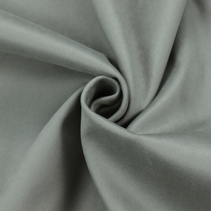 Annecy Water Repellent Velvet in Sage. The fabric features a dense, plush pile with a soft matte finish in a sophisticated, muted earthy green. This high-performance upholstery material offers a luxurious feel and a specialized water-resistant coating for enhanced durability and a natural, calming aesthetic.