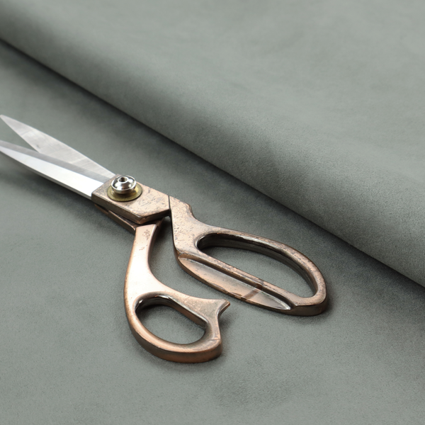 Annecy Water Repellent Velvet in Sage. The fabric features a dense, plush pile with a soft matte finish in a sophisticated, muted earthy green. This high-performance upholstery material offers a luxurious feel and a specialized water-resistant coating for enhanced durability and a natural, calming aesthetic.