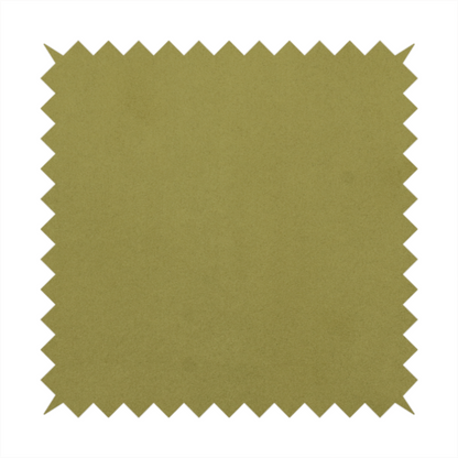Annecy Water Repellent Velvet in Olive. The fabric features a dense, plush pile with a soft matte finish in a warm, mossy green tone. This high-performance upholstery material offers a luxurious feel and a specialized water-resistant coating for superior durability and a timeless, organic look.