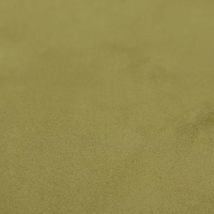 Annecy Water Repellent Velvet in Olive. The fabric features a dense, plush pile with a soft matte finish in a warm, mossy green tone. This high-performance upholstery material offers a luxurious feel and a specialized water-resistant coating for superior durability and a timeless, organic look.