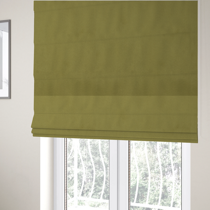 The fabric used to create these Roman blinds features a dense, plush pile with a soft matte finish in a warm, mossy green tone. This high-performance upholstery material offers a luxurious feel and a specialized water-resistant coating for superior durability and a timeless, organic look.