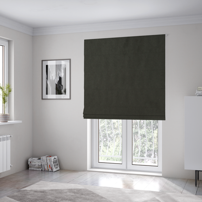 The fabric used to create these Roman blinds features a dense, plush pile with a soft matte finish in a deep, rich evergreen shade. This high-performance upholstery material offers a luxurious feel and a specialized water-resistant coating for superior durability and a classic, sophisticated look.
