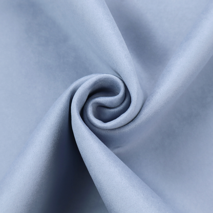 Annecy Water Repellent Velvet in Sky Blue. The fabric showcases a dense, uniform pile in a soft, serene powder blue. This high-performance upholstery material combines a luxurious matte aesthetic with a water-resistant finish, perfect for durable yet stylish furniture.