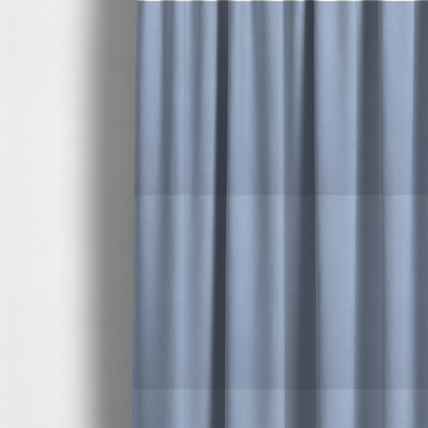 The fabric used to create these made-to-measure curtains showcases a dense, uniform pile in a soft, serene powder blue. This high-performance upholstery material combines a luxurious matte aesthetic with a water-resistant finish, perfect for durable yet stylish furniture.