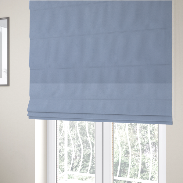 The fabric used to create these Roman blinds showcases a dense, uniform pile in a soft, serene powder blue. This high-performance upholstery material combines a luxurious matte aesthetic with a water-resistant finish, perfect for durable yet stylish furniture.