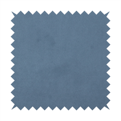 Annecy Water Repellent Velvet in Steel Blue. The fabric features a dense, plush pile with a soft matte finish in a sophisticated, mid-toned greyish-blue. This high-performance upholstery material offers a luxurious feel and a specialized water-resistant coating for superior durability and a calm, modern look.