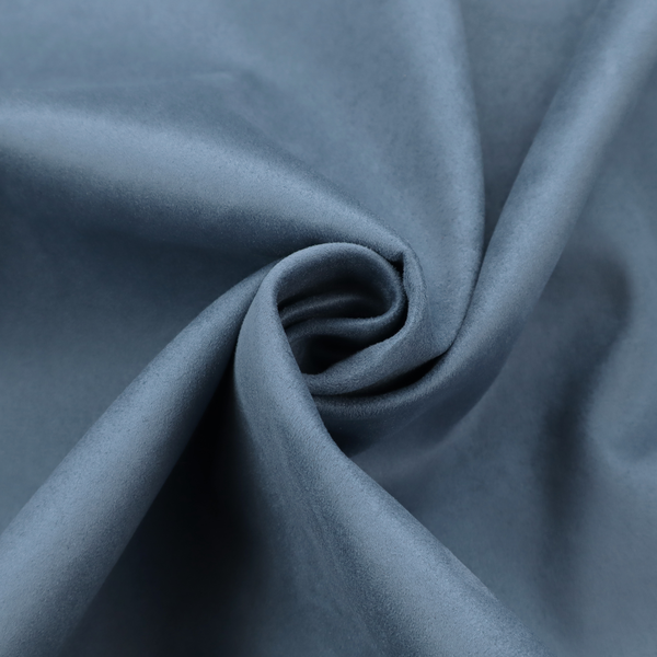 Annecy Water Repellent Velvet in Steel Blue. The fabric features a dense, plush pile with a soft matte finish in a sophisticated, mid-toned greyish-blue. This high-performance upholstery material offers a luxurious feel and a specialized water-resistant coating for superior durability and a calm, modern look.