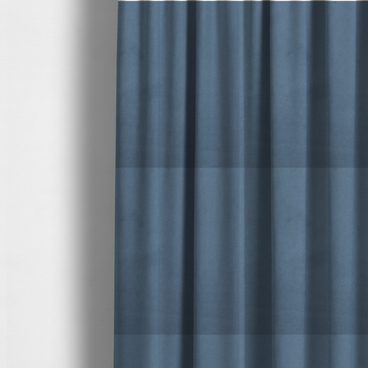 The fabric used to create these made-to-measure curtains features a dense, plush pile with a soft matte finish in a sophisticated, mid-toned greyish-blue. This high-performance upholstery material offers a luxurious feel and a specialized water-resistant coating for superior durability and a calm, modern look.
