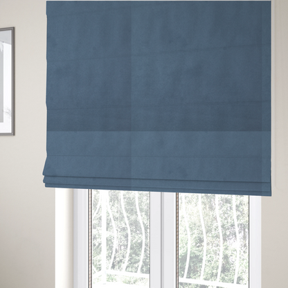 The fabric used to create these Roman blinds features a dense, plush pile with a soft matte finish in a sophisticated, mid-toned greyish-blue. This high-performance upholstery material offers a luxurious feel and a specialized water-resistant coating for superior durability and a calm, modern look.