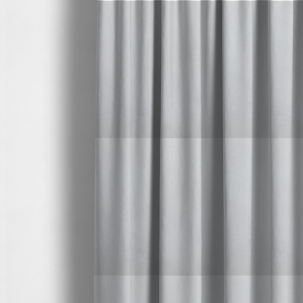 The fabric used to create these made-to-measure curtains features a dense, plush pile with a soft matte finish in a bright, clean light grey. This high-performance upholstery material offers a luxurious texture and a specialized water-resistant coating for a modern, durable aesthetic.