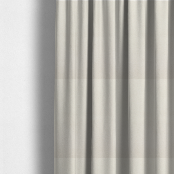 The fabric used to create these made-to-measure curtains features a dense, plush pile with a clean, matte finish in a brilliant pure white. This high-performance upholstery material offers a luxurious feel and a specialized water-resistant coating for superior durability.