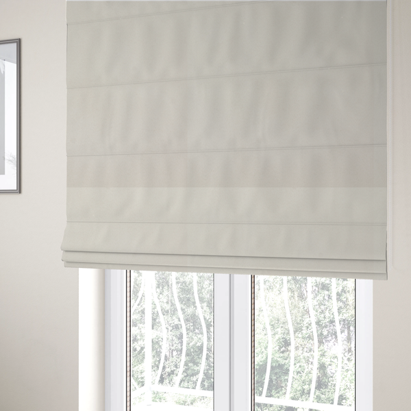 The fabric used to create these Roman blinds features a dense, plush pile with a clean, matte finish in a brilliant pure white. This high-performance upholstery material offers a luxurious feel and a specialized water-resistant coating for superior durability.