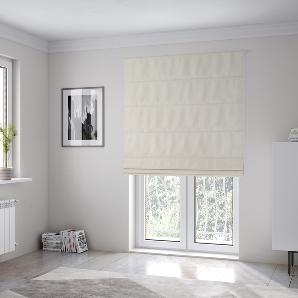 The fabric used to create these Roman blinds features a dense, plush pile with a clean, matte finish in a brilliant pure white. This high-performance upholstery material offers a luxurious feel and a specialized water-resistant coating for superior durability.