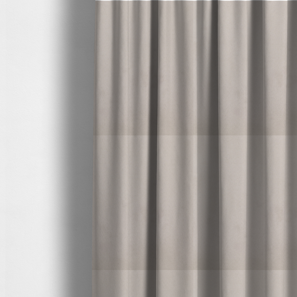 The fabric used to create these made-to-measure curtains features a dense, plush pile with a soft matte finish in a sophisticated, pale neutral grey. This high-performance upholstery material offers a luxurious feel and a specialized water-resistant coating for superior durability and a timeless, elegant look.