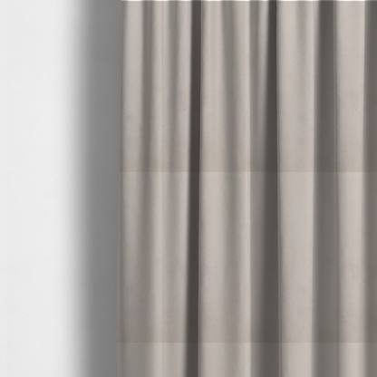 The fabric used to create these made-to-measure curtains features a dense, plush pile with a soft matte finish in a sophisticated, pale neutral grey. This high-performance upholstery material offers a luxurious feel and a specialized water-resistant coating for superior durability and a timeless, elegant look.