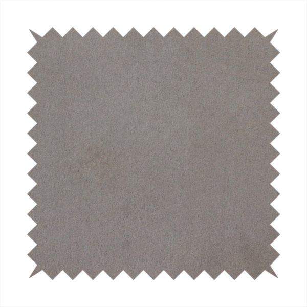 Annecy Water Repellent Velvet in Storm. The fabric features a dense, uniform pile with a soft matte finish in a deep, moody brownish-grey. This high-performance upholstery material offers a luxurious texture and a specialized water-resistant coating for a sophisticated, durable finish.