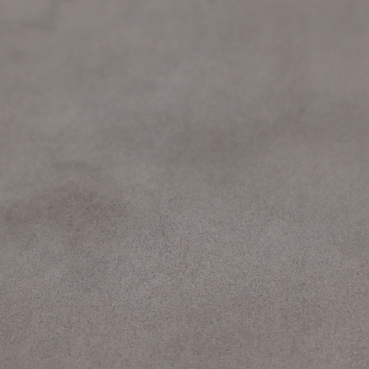 Annecy Water Repellent Velvet in Storm. The fabric features a dense, uniform pile with a soft matte finish in a deep, moody brownish-grey. This high-performance upholstery material offers a luxurious texture and a specialized water-resistant coating for a sophisticated, durable finish.