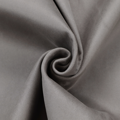Annecy Water Repellent Velvet in Storm. The fabric features a dense, uniform pile with a soft matte finish in a deep, moody brownish-grey. This high-performance upholstery material offers a luxurious texture and a specialized water-resistant coating for a sophisticated, durable finish.