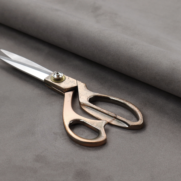 Annecy Water Repellent Velvet in Storm. The fabric features a dense, uniform pile with a soft matte finish in a deep, moody brownish-grey. This high-performance upholstery material offers a luxurious texture and a specialized water-resistant coating for a sophisticated, durable finish.