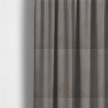 The fabric used to create these made-to-measure curtains features a dense, uniform pile with a soft matte finish in a deep, moody brownish-grey. This high-performance upholstery material offers a luxurious texture and a specialized water-resistant coating for a sophisticated, durable finish.