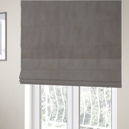 The fabric used to create these Roman blinds features a dense, uniform pile with a soft matte finish in a deep, moody brownish-grey. This high-performance upholstery material offers a luxurious texture and a specialized water-resistant coating for a sophisticated, durable finish.