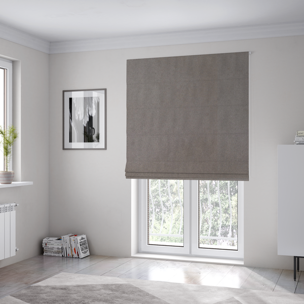 The fabric used to create these Roman blinds features a dense, uniform pile with a soft matte finish in a deep, moody brownish-grey. This high-performance upholstery material offers a luxurious texture and a specialized water-resistant coating for a sophisticated, durable finish.