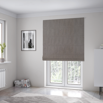 The fabric used to create these Roman blinds features a dense, uniform pile with a soft matte finish in a deep, moody brownish-grey. This high-performance upholstery material offers a luxurious texture and a specialized water-resistant coating for a sophisticated, durable finish.