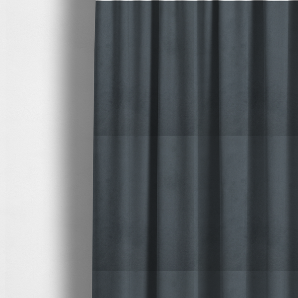 The fabric used to create these made-to-measure curtains features a dense, plush pile with a soft matte finish in a sophisticated mid-to-dark neutral grey. This high-performance upholstery material offers a luxurious feel and a specialized water-resistant coating for superior durability and a sleek, modern aesthetic.