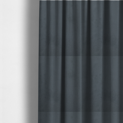 The fabric used to create these made-to-measure curtains features a dense, plush pile with a soft matte finish in a sophisticated mid-to-dark neutral grey. This high-performance upholstery material offers a luxurious feel and a specialized water-resistant coating for superior durability and a sleek, modern aesthetic.