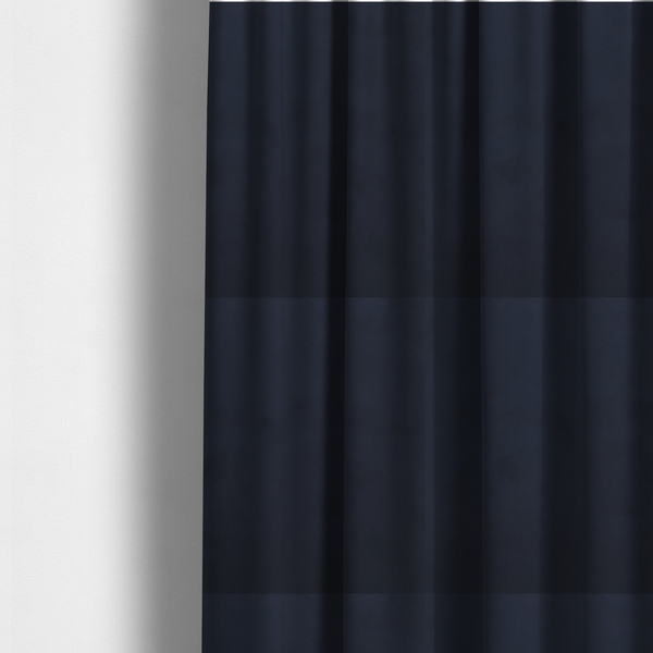 The fabric used to create these made-to-measure curtains showcases a dense, uniform pile with a soft matte finish in a deep, midnight blue. This high-performance upholstery material combines a luxurious texture with a specialized water-resistant coating for a sophisticated and durable finish.
