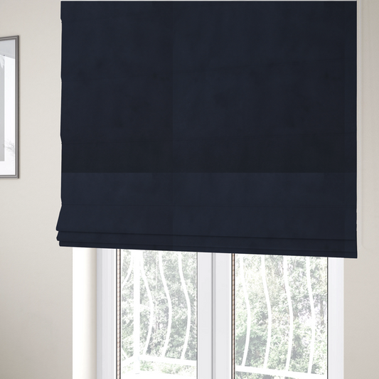 The fabric used to create these Roman blinds showcases a dense, uniform pile with a soft matte finish in a deep, midnight blue. This high-performance upholstery material combines a luxurious texture with a specialized water-resistant coating for a sophisticated and durable finish.