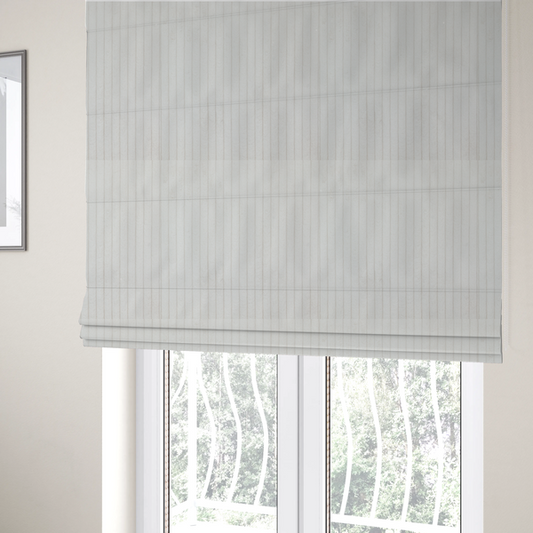 The fabric used to create these Roman blinds is a white corduroy with a consistent vertical ribbed texture.