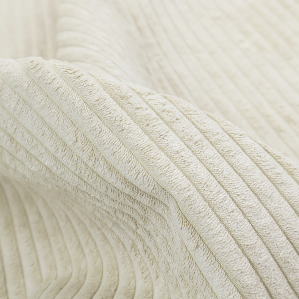 This fabric is an off-white or cream-coloured corduroy featuring a consistent, vertical ribbed texture.