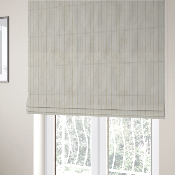 The fabric used to create these Roman blinds is an off-white or cream-coloured corduroy featuring a consistent, vertical ribbed texture.