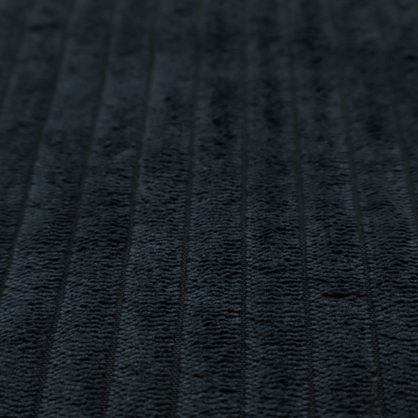This fabric is a dark charcoal or black corduroy with a consistent vertical ribbed texture.