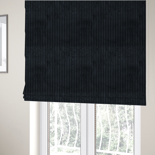 The fabric used to create these Roman blinds is a dark charcoal or black corduroy with a consistent vertical ribbed texture.
