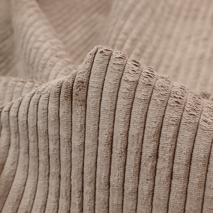 This fabric is a beige or light taupe corduroy featuring a consistent vertical ribbed texture.