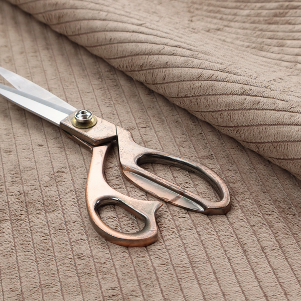 This fabric is a beige or light taupe corduroy featuring a consistent vertical ribbed texture.