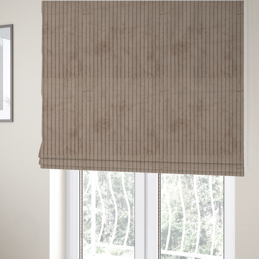 The fabric used to create these Roman blinds is a beige or light taupe corduroy featuring a consistent vertical ribbed texture.