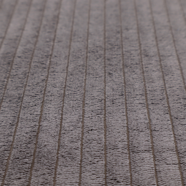 This fabric is a cool brown corduroy featuring a consistent vertical ribbed texture.