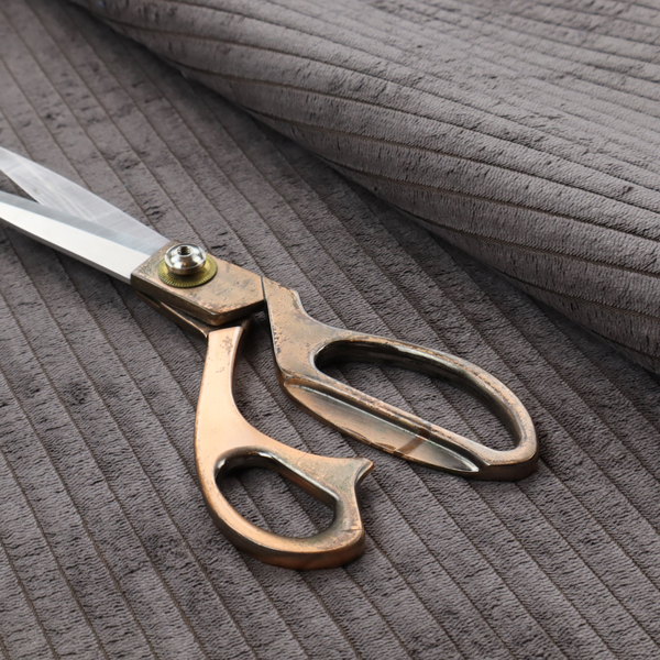 This fabric is a cool brown corduroy featuring a consistent vertical ribbed texture.